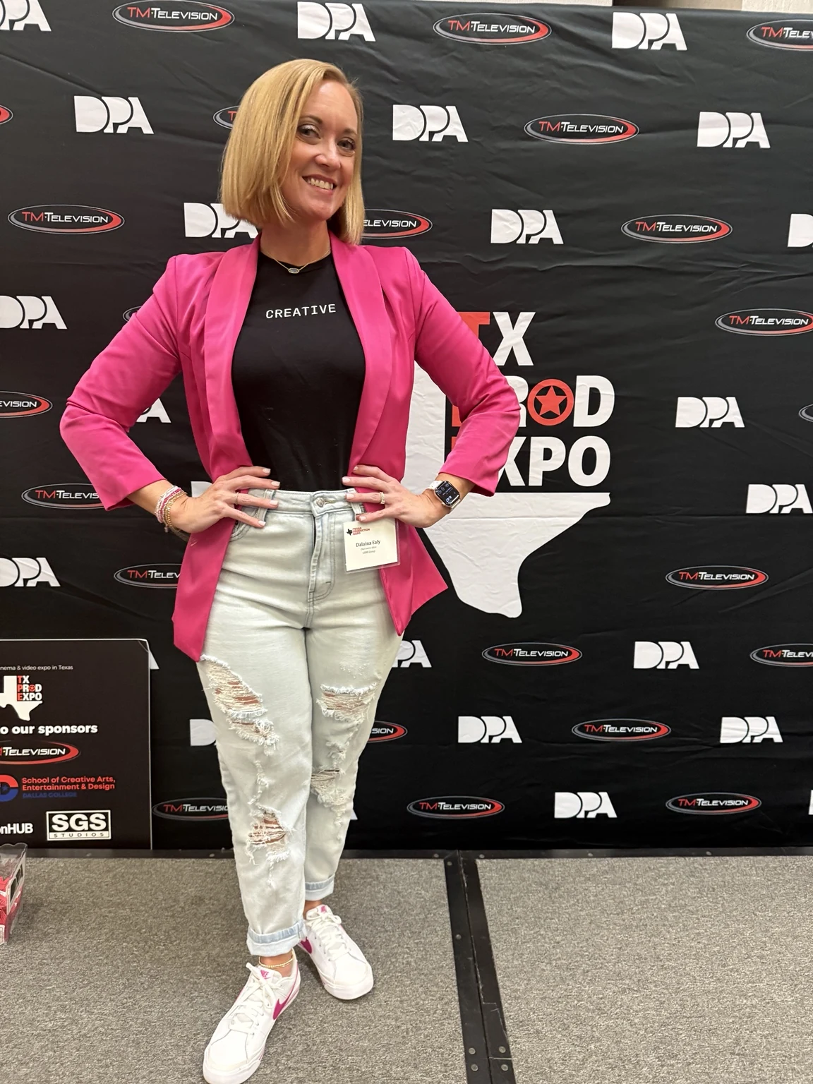 Dalaina at a creative industry event in a bright pink blazer