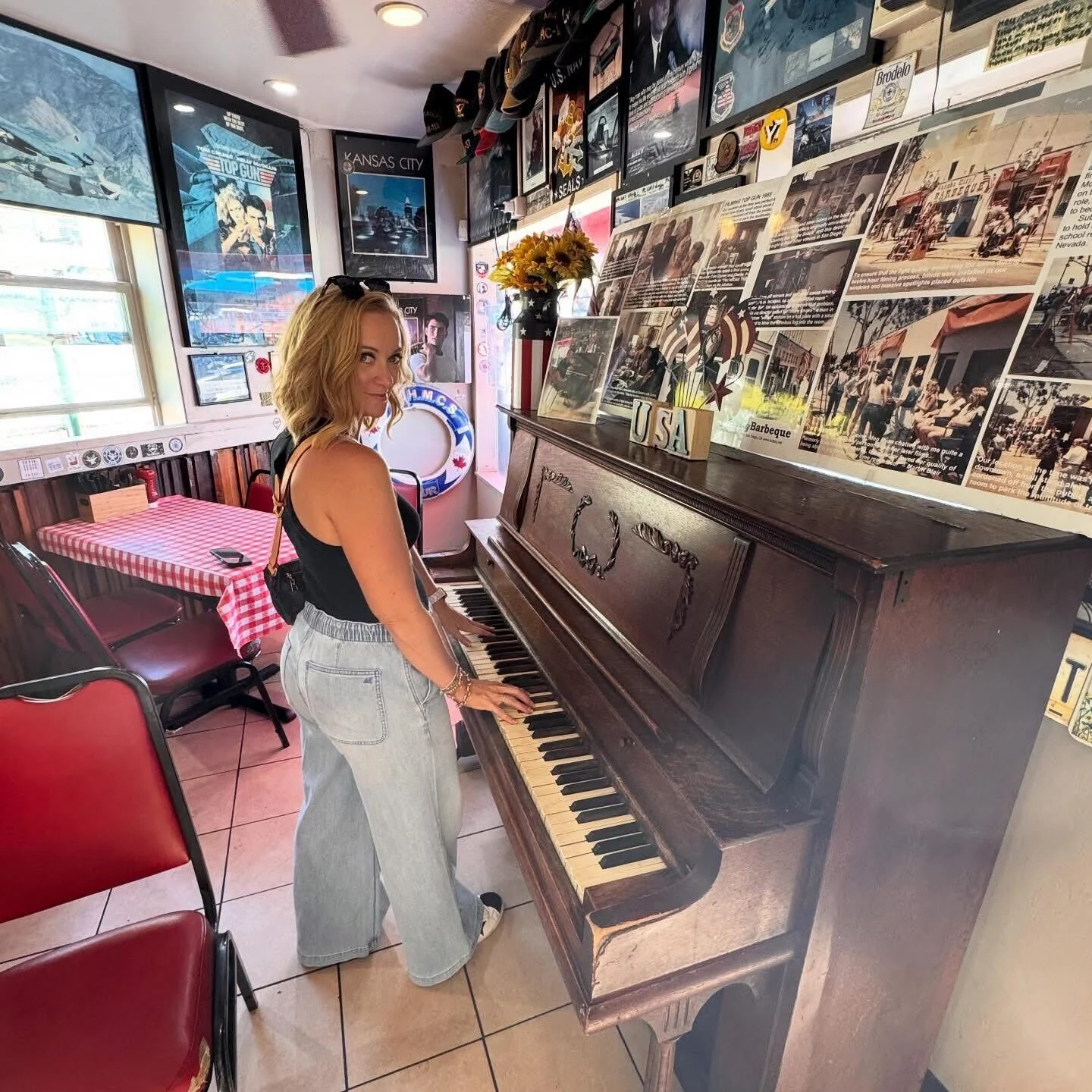 Dalaina at a piano in a music-filled space